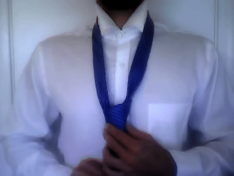 Shows tightening the knot and adjusting the collar over the tie.