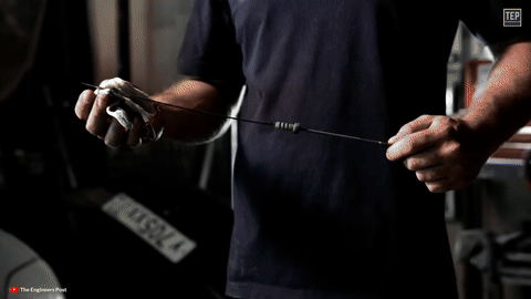 Shows oil being smeared between fingers.