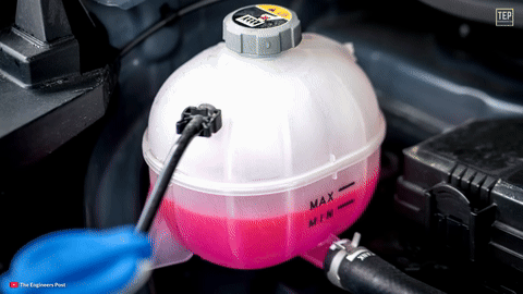 Shows coolant levels being checked.