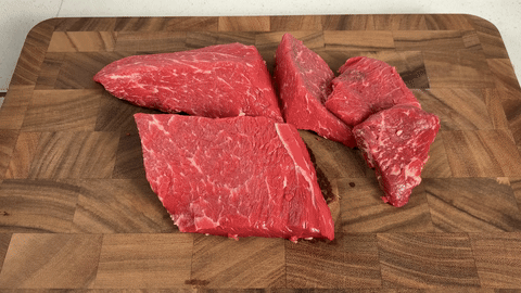 Shows the process of slicing beef against the grain and preparing it for freezing.