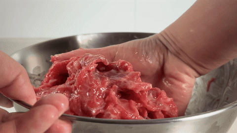 Shows the beef being covered with plastic wrap and set aside.